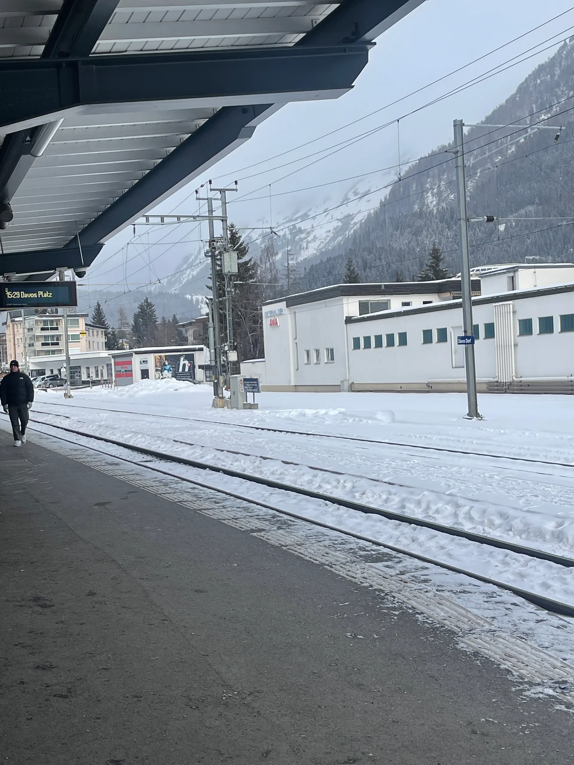 A Swiss train waiting at a snowy mountain platform